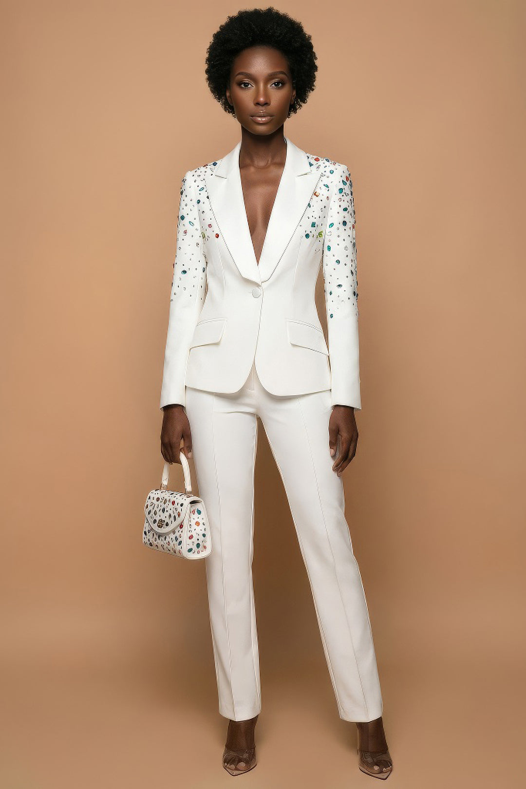 Woman wearing a white suit with floral embellishments on a beige background