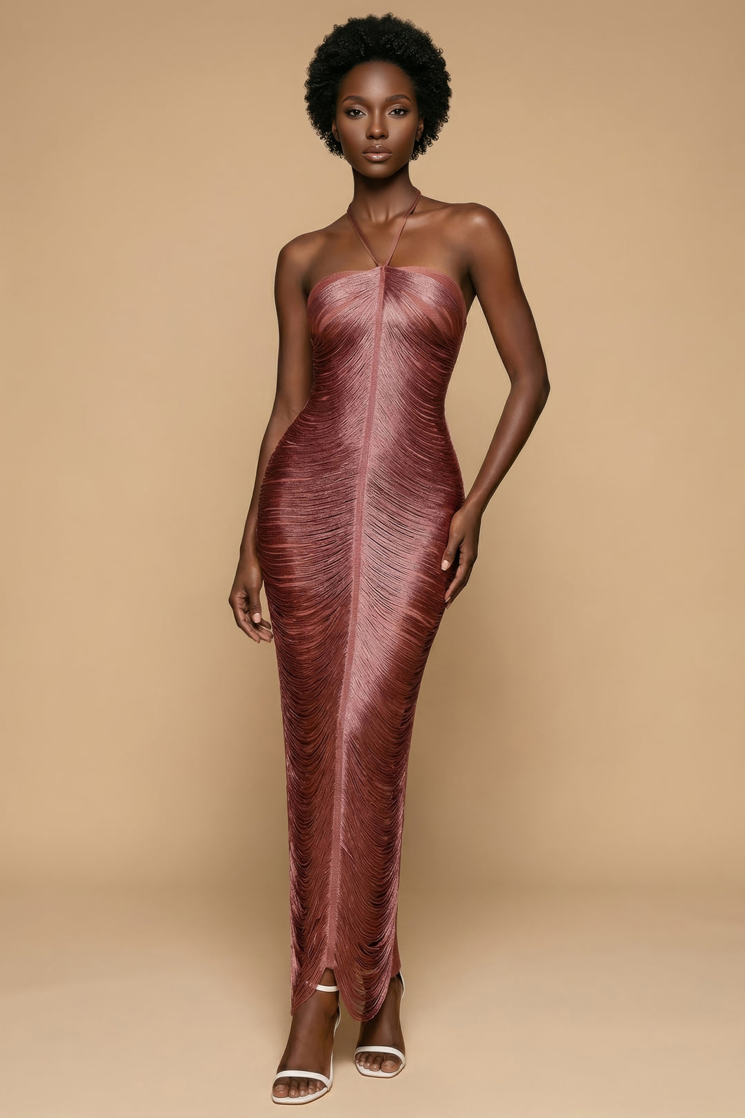 Model wearing a strapless, long, maroon dress against a beige background