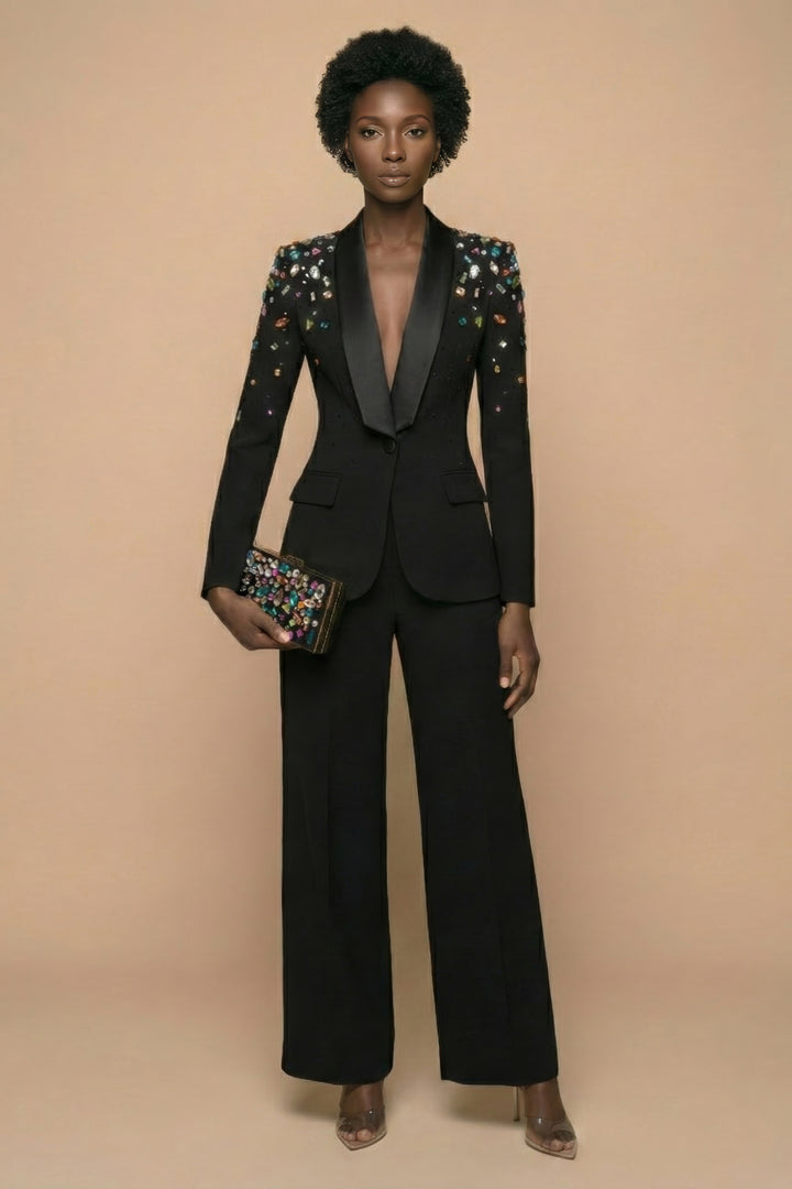 Woman wearing a black suit with floral embellishments on a beige background